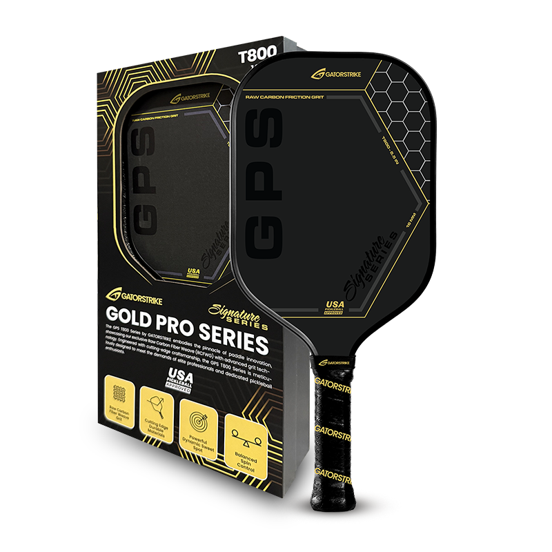 A black and gold GADOSTRIKE Gold Pro Series pickleball paddle is shown next to its matching box, featuring GPS branding, hexagon designs, and icons for durability, control, and USA manufacturing.