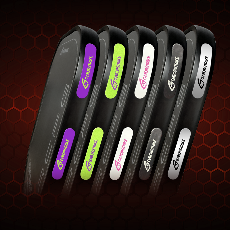 Five gray Goostrike products stand upright in a row, each with a differently colored accent: purple, green, white, neon yellow, and black. The Goostrike logo is visible on each.