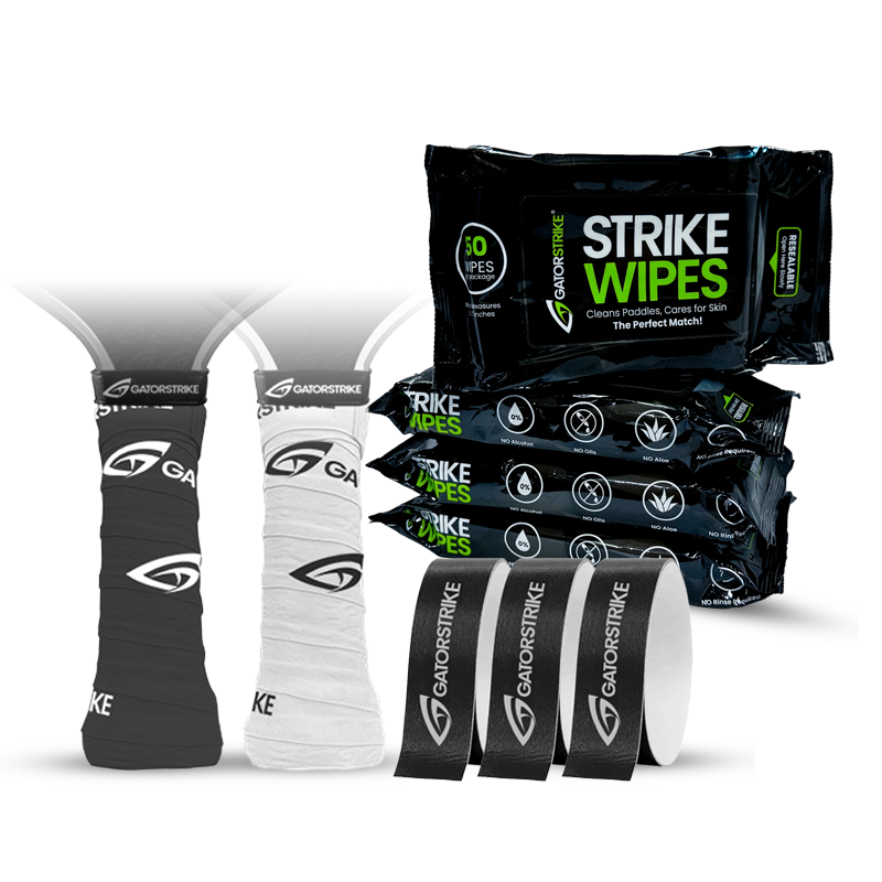 A bundle of sports gear including black and white grip tapes wrapped around handles, labeled Gavostrike, plus stacked packs of Strike Wipes and several loose grip tapes in black and white.