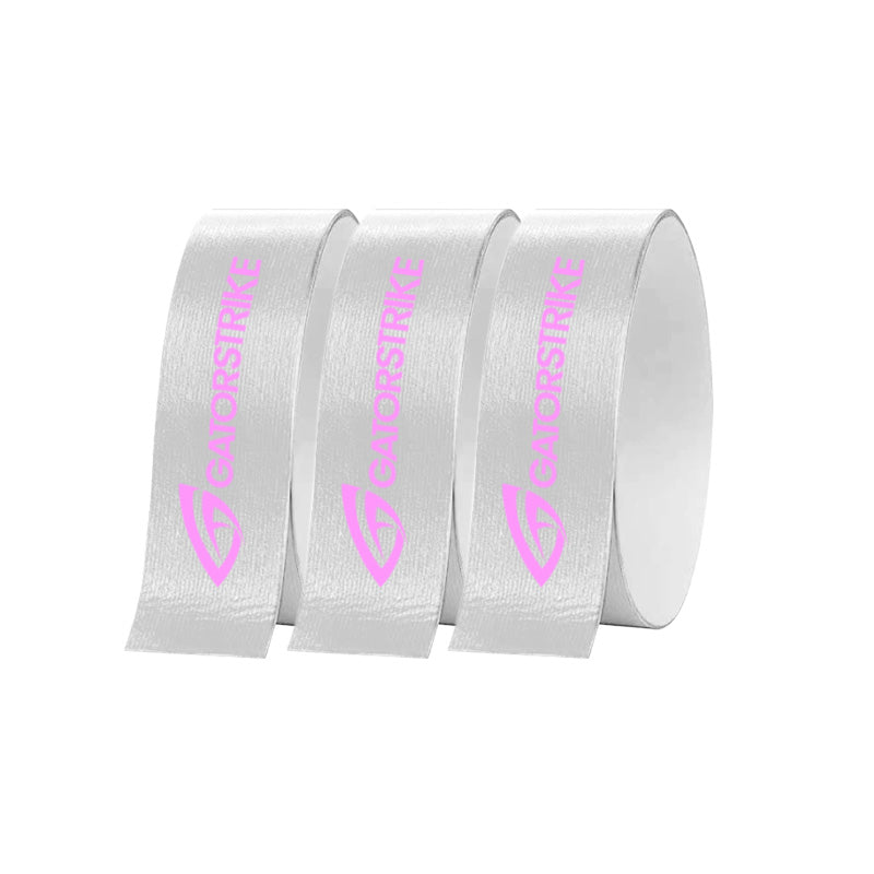 Three upright, partially overlapping rolls of GATORSTRIKE™ Edge Guard Tape - 3 Pack are shown in white with a pink logo and graphic, perfect for protecting your pickleball paddle’s edge.
