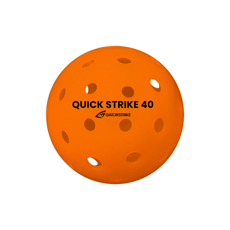 An orange perforated plastic GATORSTRIKE™ Quick Strike Pickleball, featuring black "QUICK STRIKE 40" and "GATORSTRIKE" text, is shown against a white background—designed for ultimate consistency and competitive play (100 Pack).